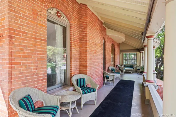 a balcony with furniture and a potted plant