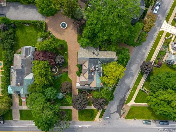 an aerial view of a house with garden space and street view