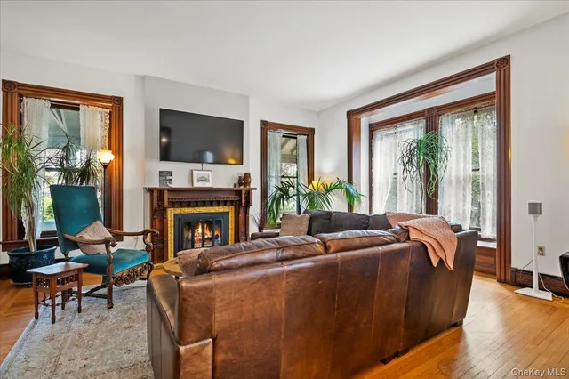 a living room with furniture a flat screen tv and a fireplace