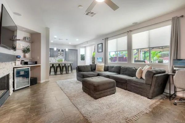 a living room with furniture and a kitchen