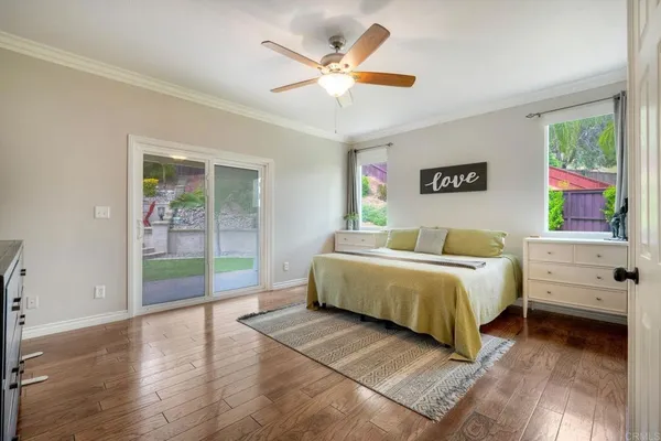 a spacious bedroom with a bed and a large window
