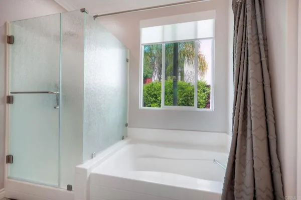 a bathroom with a bathtub and a shower