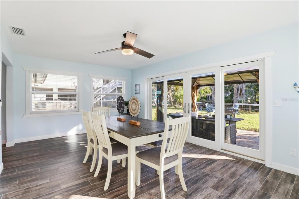 3619 North Suwanee Point Crystal River, FL 34428 - Photo 16 of 54 a view of a dining room with furniture window and wooden floor