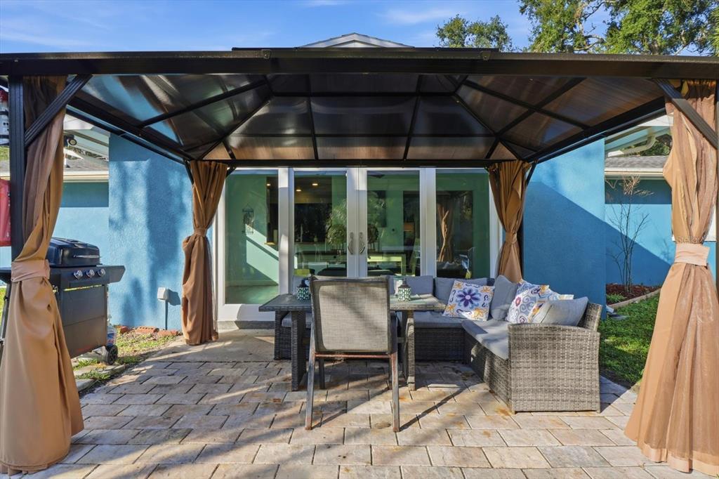 3619 North Suwanee Point Crystal River, FL 34428 - Photo 30 of 54 a patio with a table and chairs under an umbrella