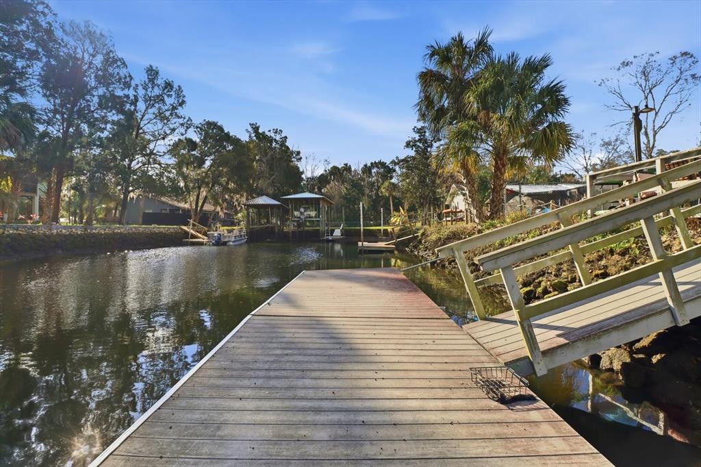3619 North Suwanee Point Crystal River, FL 34428 - Photo 36 of 54 a wooden pier with boats in a lake