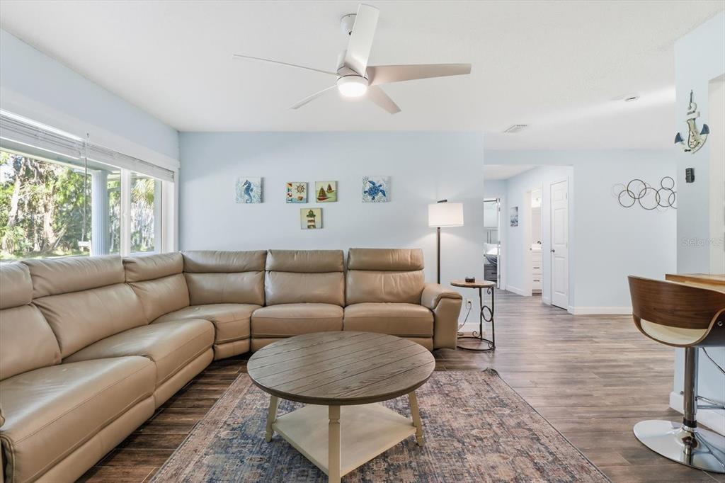 3619 North Suwanee Point Crystal River, FL 34428 - Photo 8 of 54 a living room with furniture a table and wooden floor