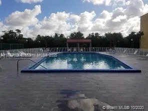 a view of a swimming pool with a yard