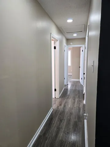 a view of hallway with wooden floor