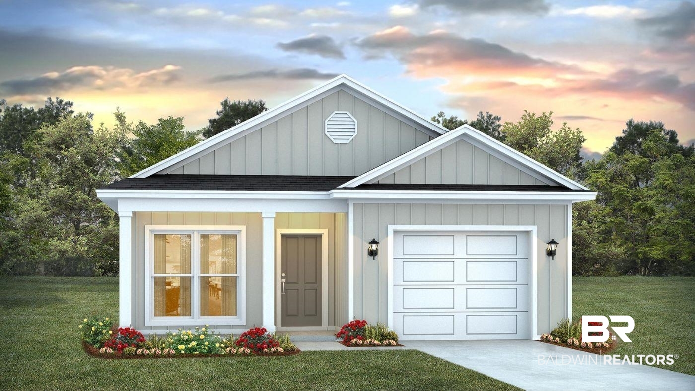 View of front facade with a yard and a garage