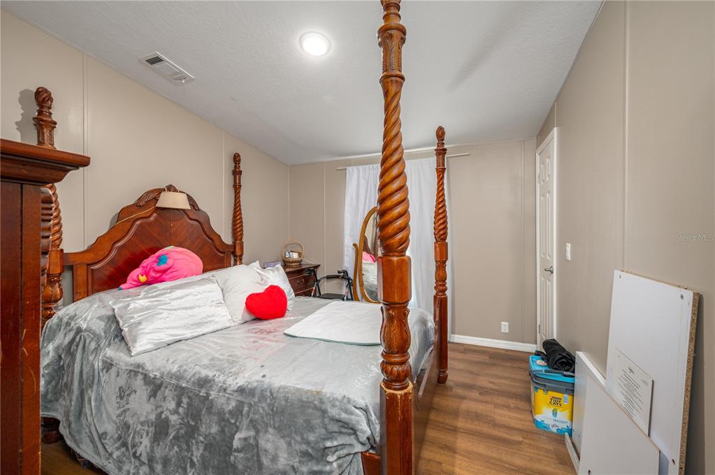 15079 Brahma Road Polk City, FL 33868 - Photo 32 of 40 a bedroom with a bed and a window