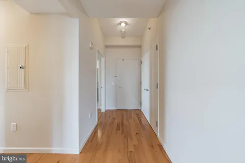 a view of a hallway with wooden floor
