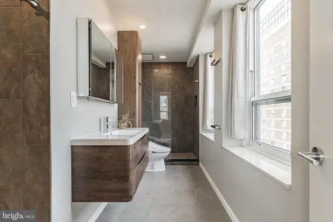 a bathroom with a sink mirror and a bathtub