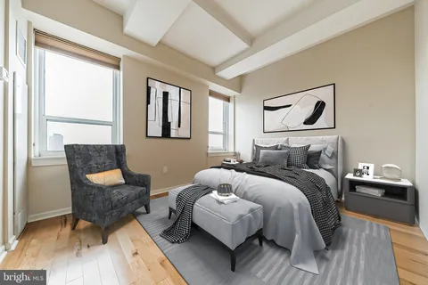 a bedroom with a bed and a chair