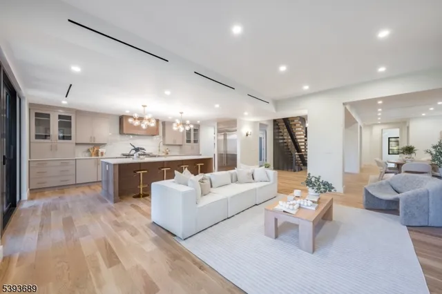 a living room with furniture and kitchen view