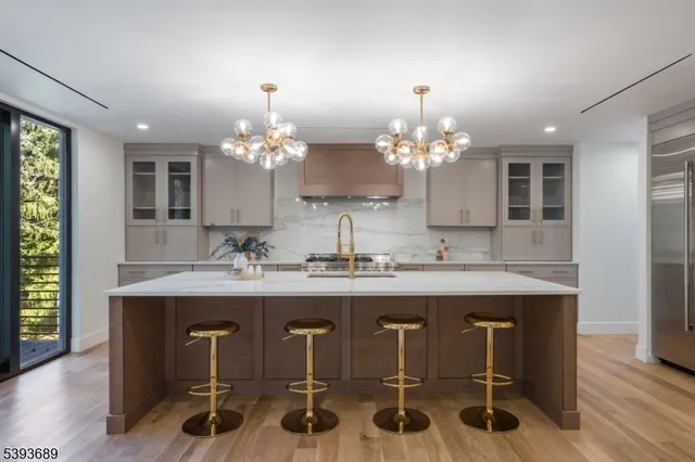 a view of a a dining room with furniture and chandelier