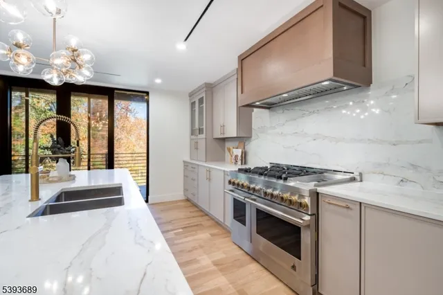 a kitchen with a stove a sink and a refrigerator