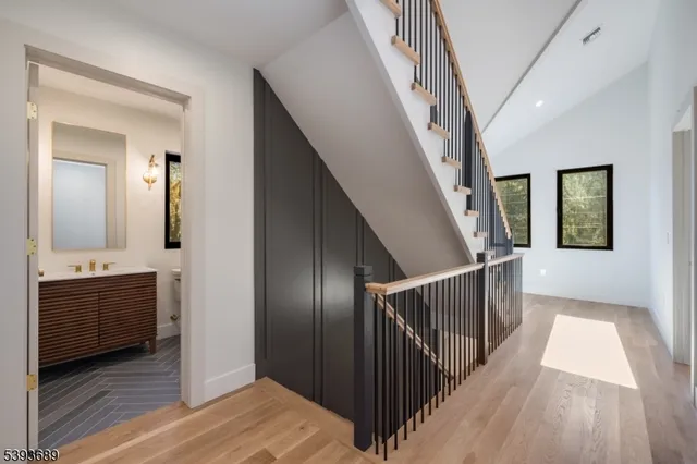 a view of a hallway view with wooden floor and staircase