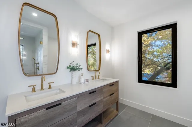 a bathroom with 2 sink and a mirror
