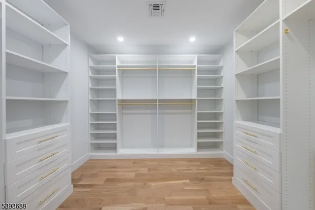 a view of walk in closet with empty racks
