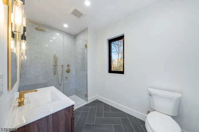a bathroom with a toilet sink and shower