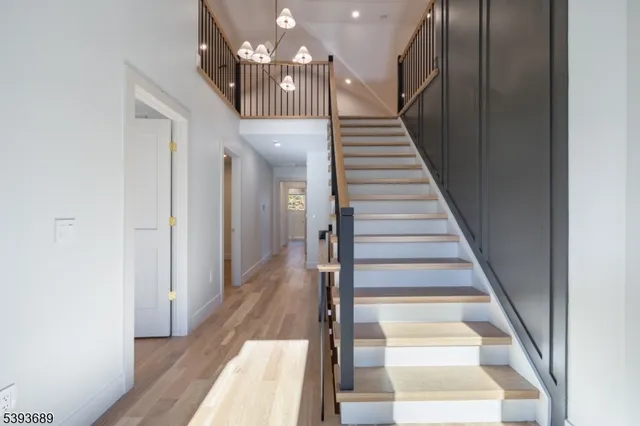 a view of entryway and hall with wooden floor