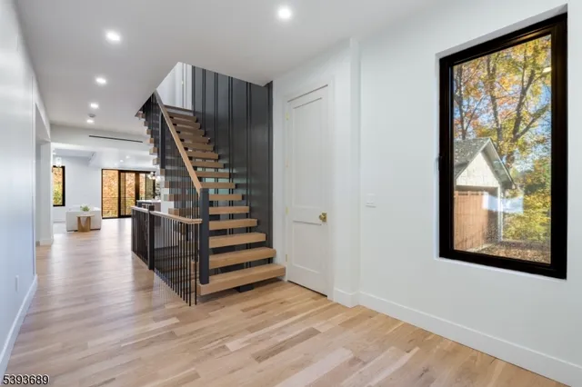 a view of entryway with wooden floor and stairs