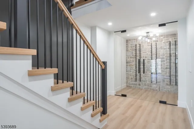 a view of staircase with white walls and railing
