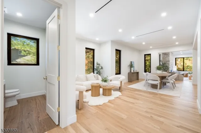 a living room with furniture and a large mirror