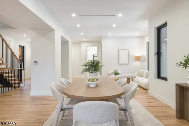 a dining room with furniture and wooden floor