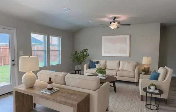 a living room with furniture and wooden floor