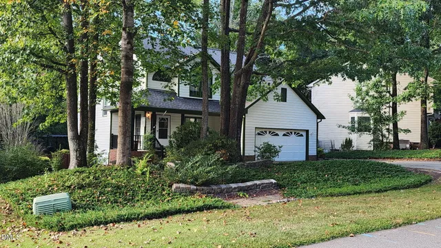 front view of house with a yard and potted plants