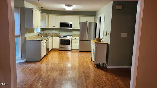 a kitchen with a refrigerator a stove top oven a sink and dishwasher