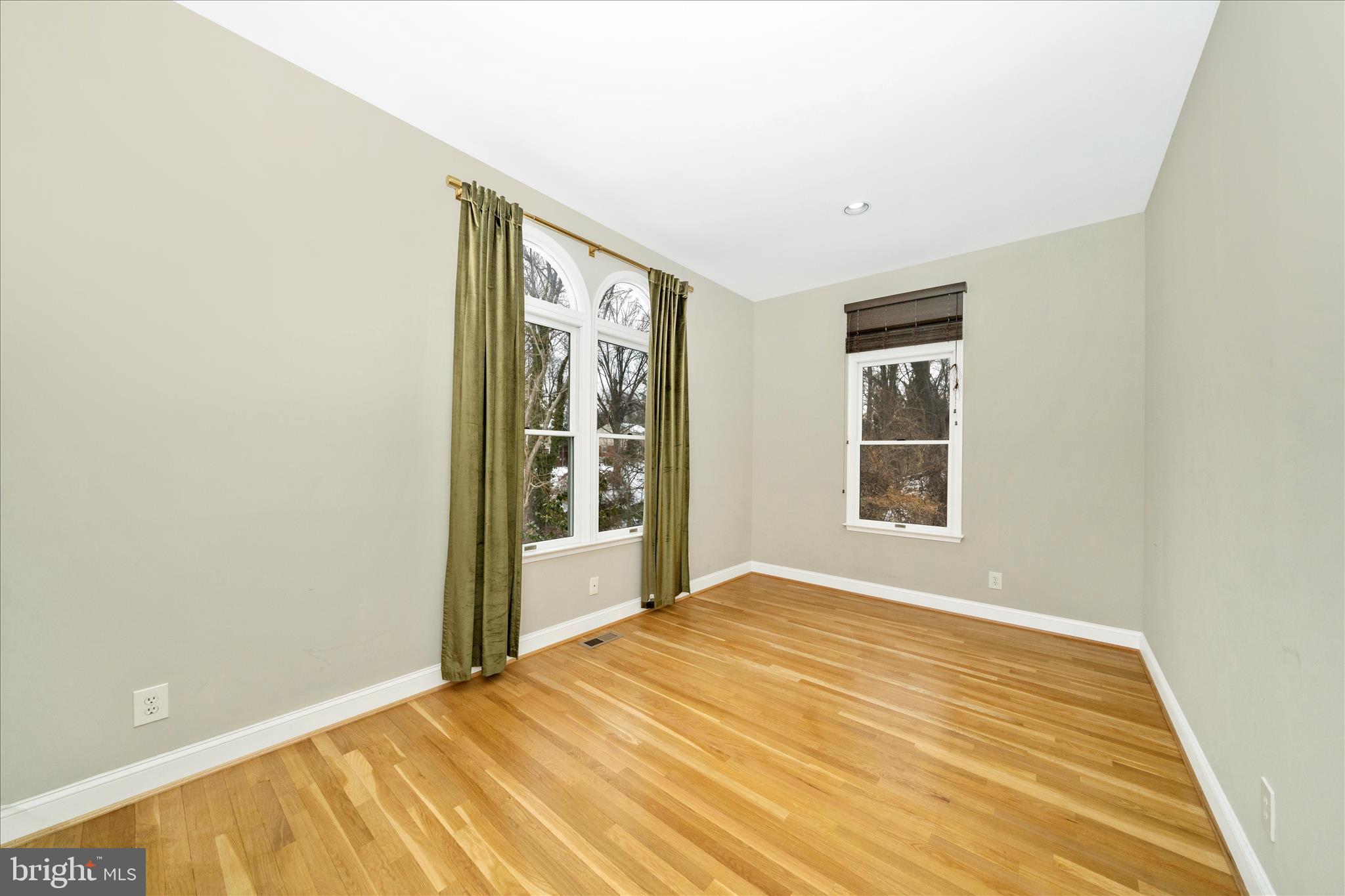 3313 Moline Road Silver Spring, MD 20902 - Photo 14 of 66 a view of an empty room with wooden floor and a window