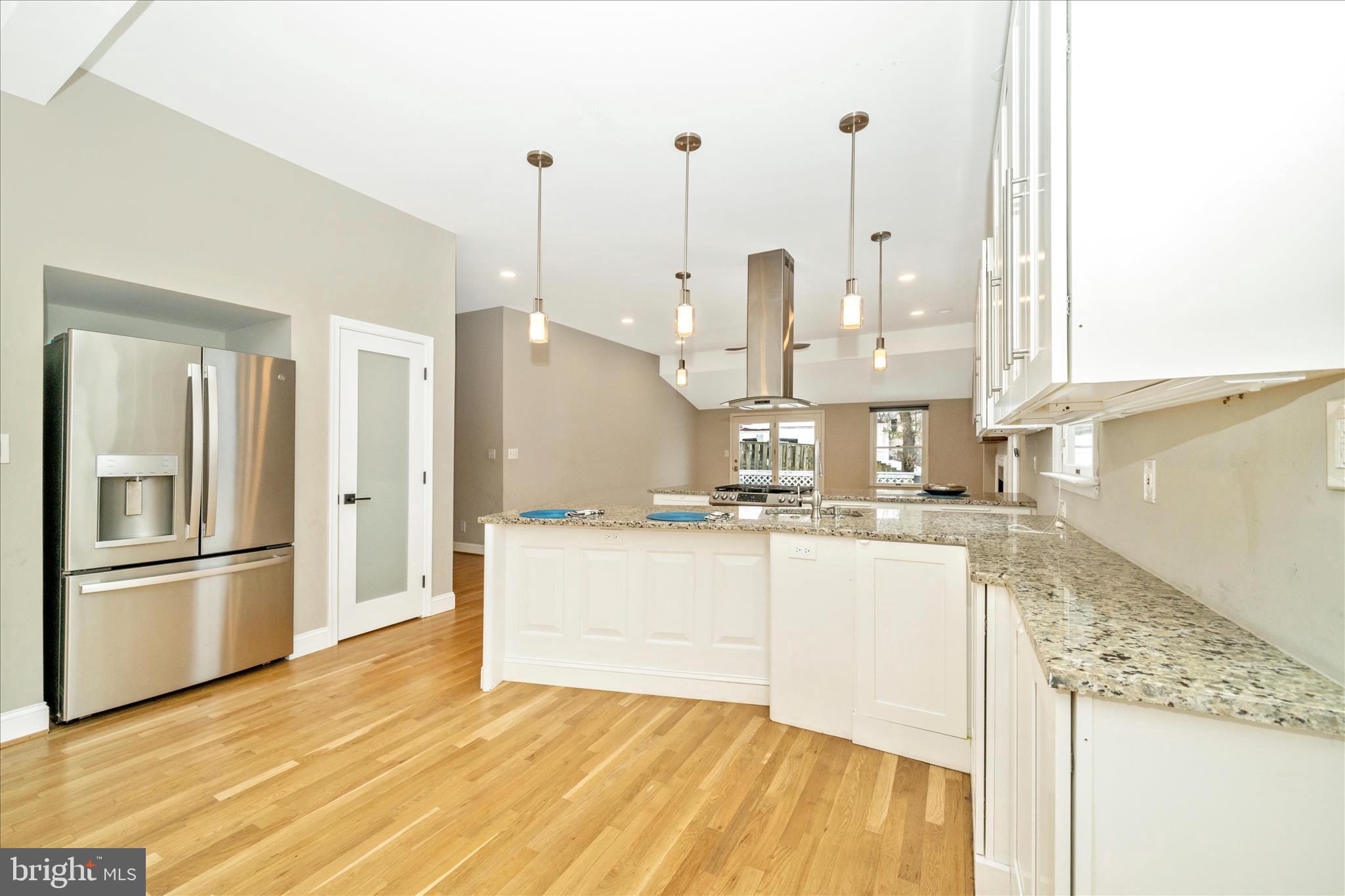 3313 Moline Road Silver Spring, MD 20902 - Photo 19 of 66 a kitchen with stainless steel appliances granite countertop a sink a stove and a wooden floors