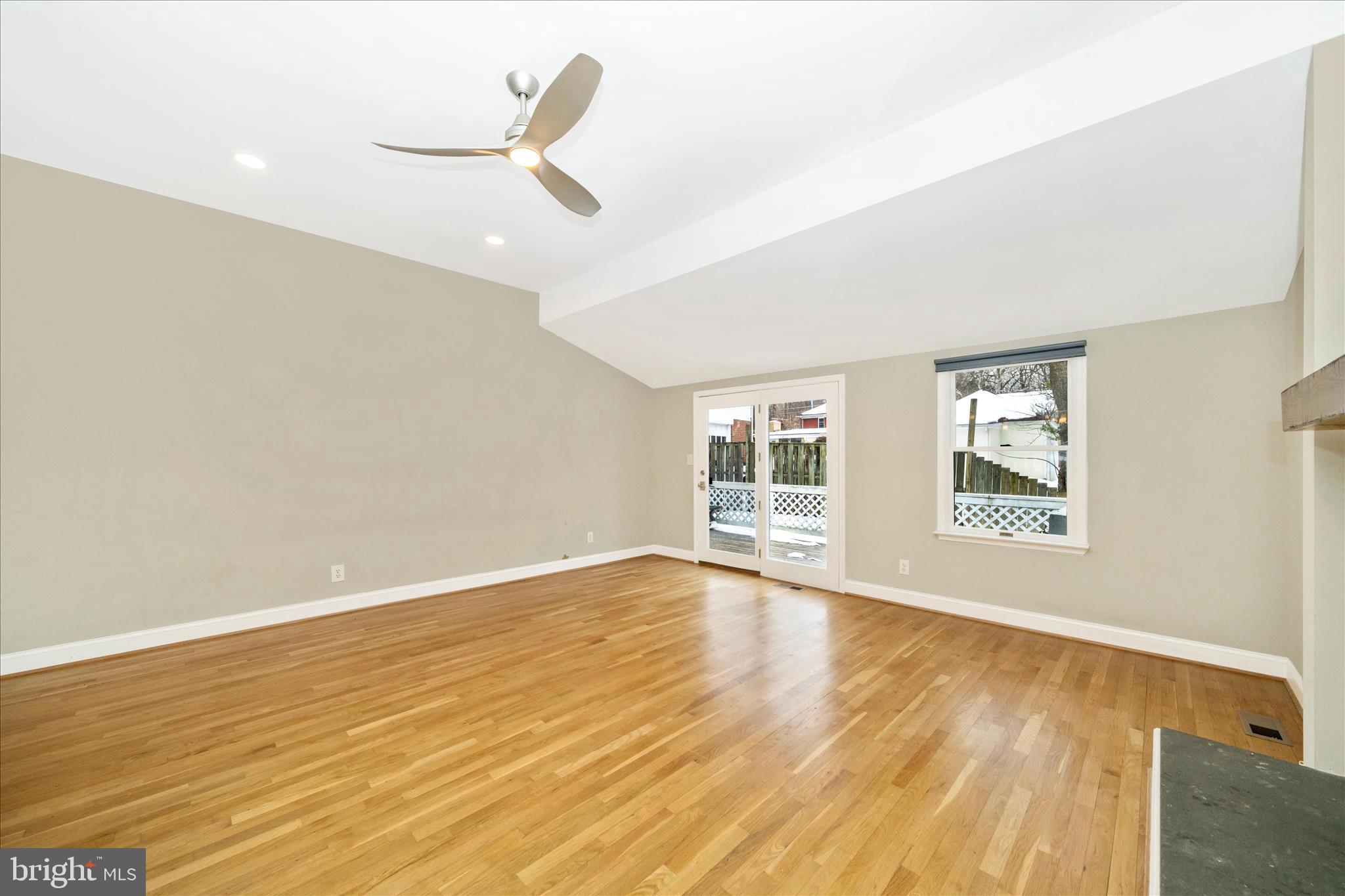 3313 Moline Road Silver Spring, MD 20902 - Photo 25 of 66 an empty room with wooden floor fan and windows