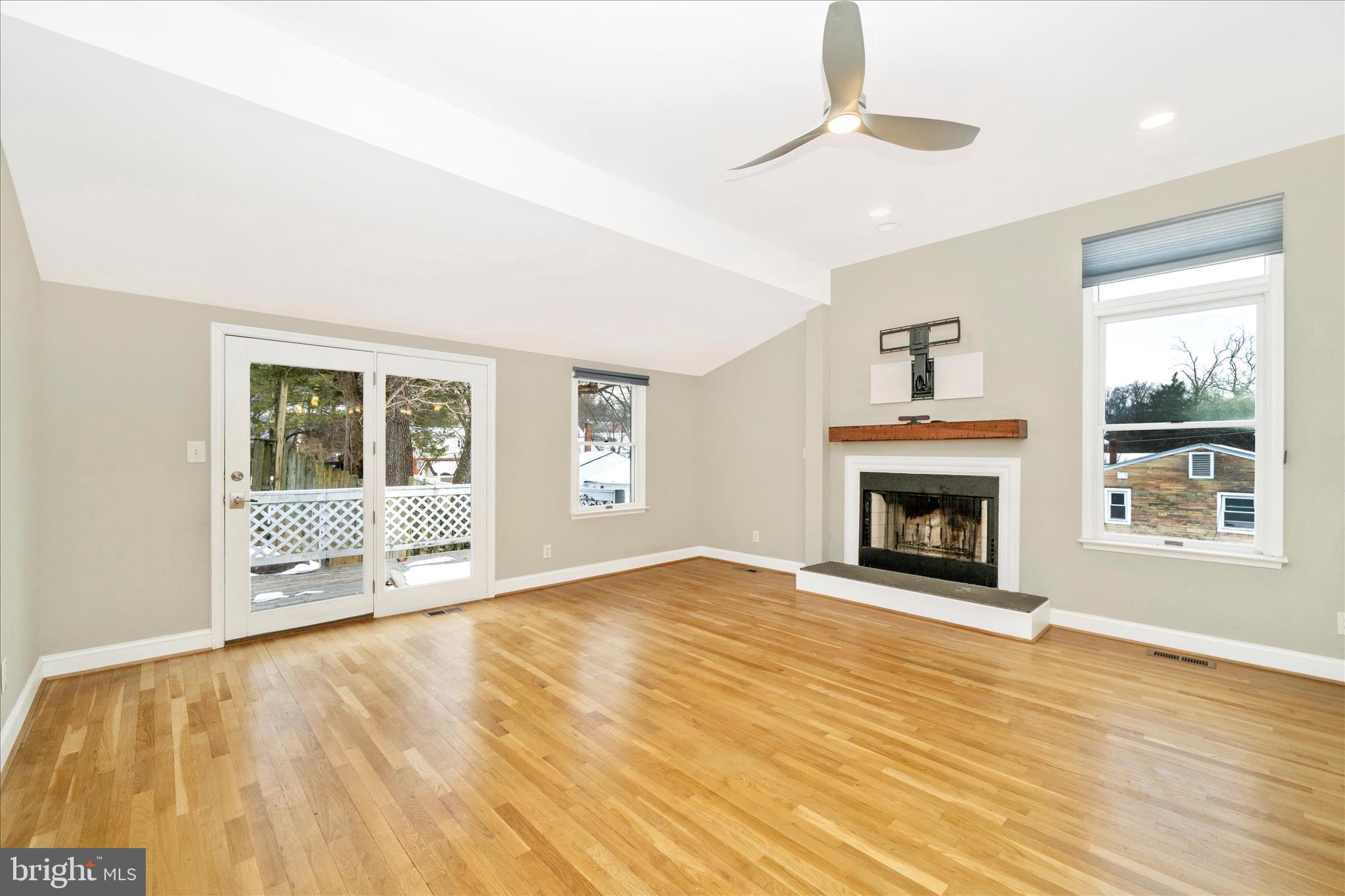 3313 Moline Road Silver Spring, MD 20902 - Photo 3 of 66 a view of empty room with wooden floor and fireplace
