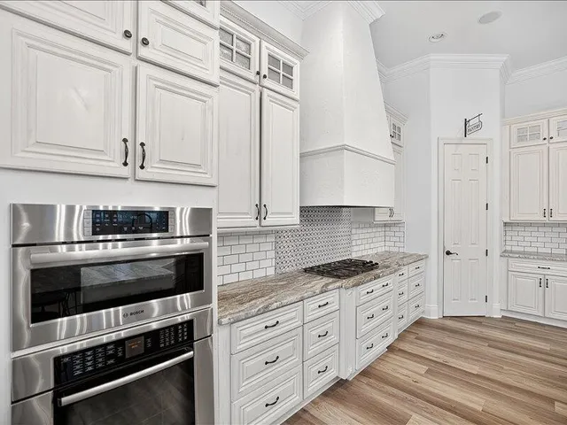 front view of a house with a yard and an trees