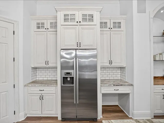 a kitchen with cabinets a sink and appliances