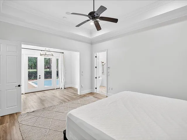 a view of a room with wooden floor swimming pool and windows
