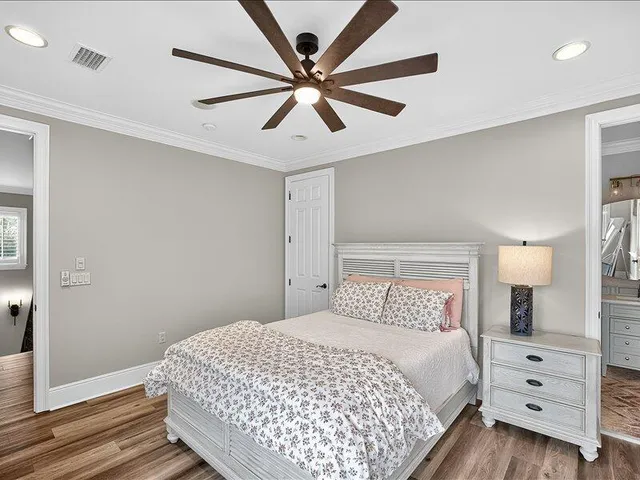 a bathroom with a toilet sink vanity and mirror