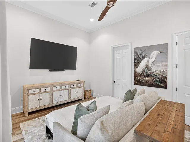 a living room with furniture and a view of kitchen
