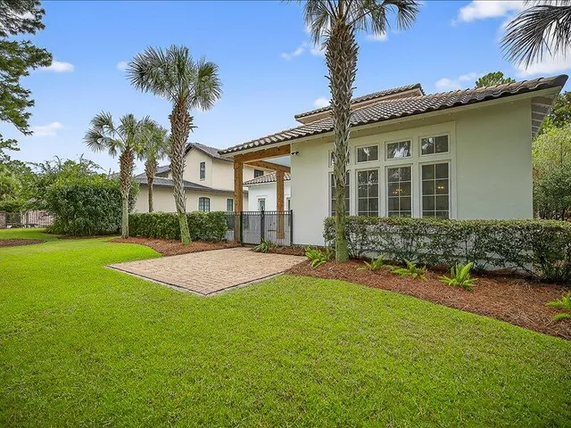a front view of a house with a garden