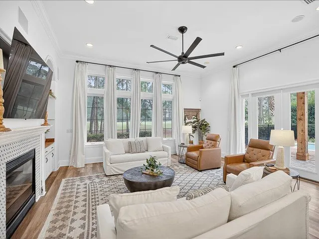 a living room with furniture a flat screen tv and a fireplace