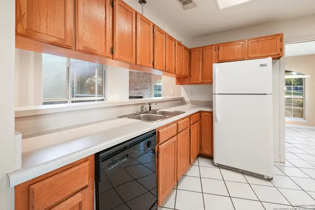 a kitchen with stainless steel appliances granite countertop a refrigerator sink and cabinets