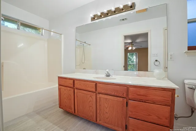 a bathroom with a double vanity sink and mirror with shower