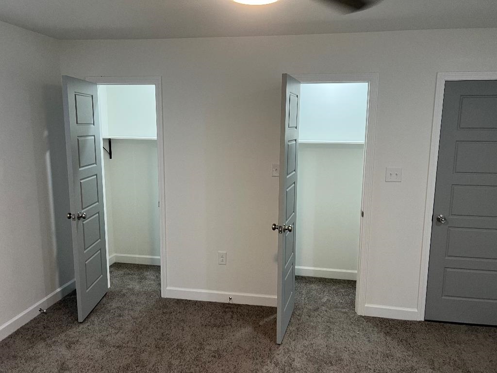 56 South Sanga Road Memphis, TN 38018 - Photo 12 of 23 Unfurnished bedroom with a spacious closet and dark carpet