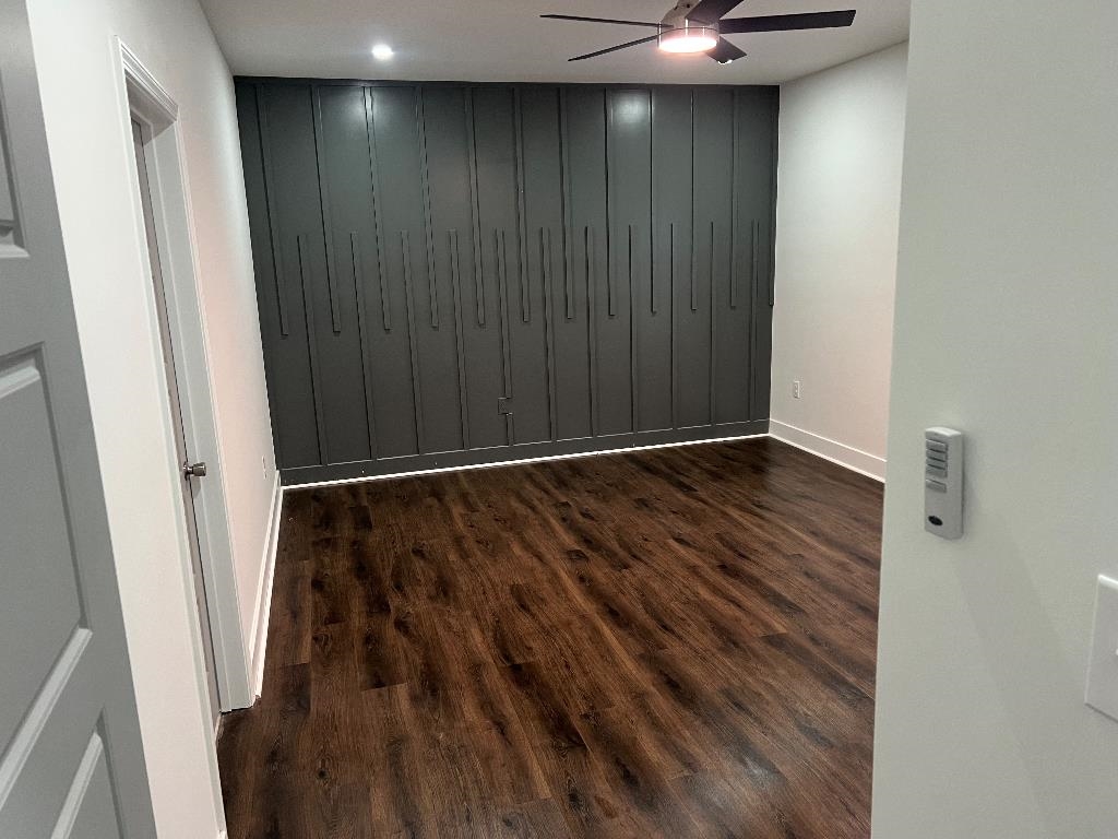 56 South Sanga Road Memphis, TN 38018 - Photo 3 of 23 Empty room with dark wood-style flooring and ceiling fan