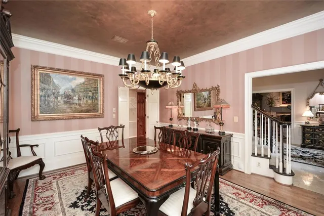 a bedroom with two beds and a dresser next to a window