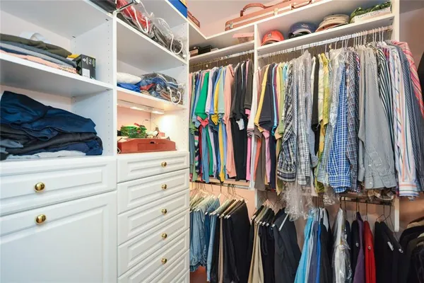 a view of a patio with a table chairs and a barbeque