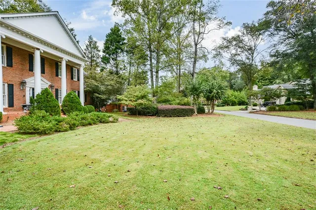 a living room with furniture a fireplace and a large window